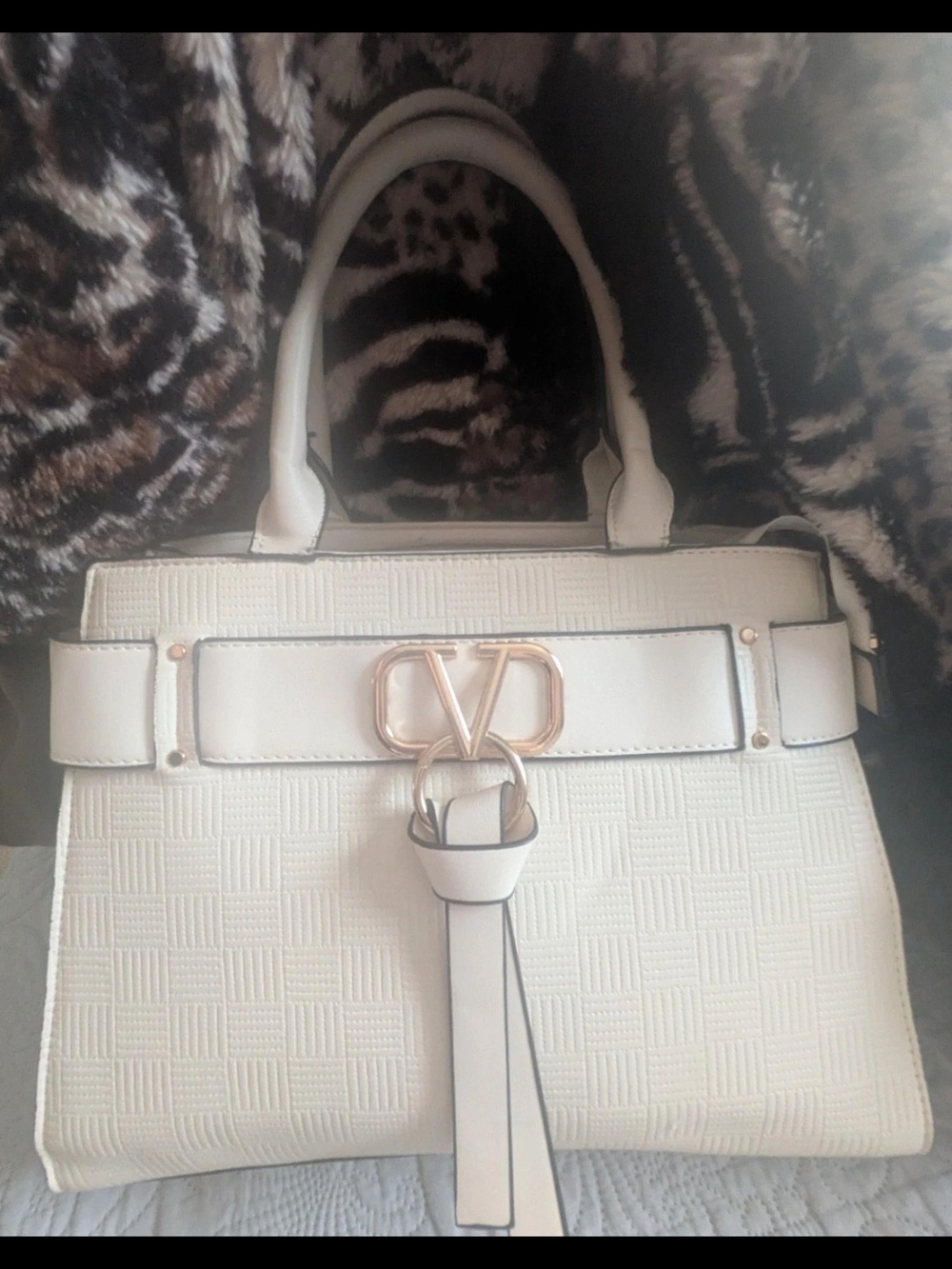Cream/White Handbag With Crossbody Strap, and Gold Logo Accents.